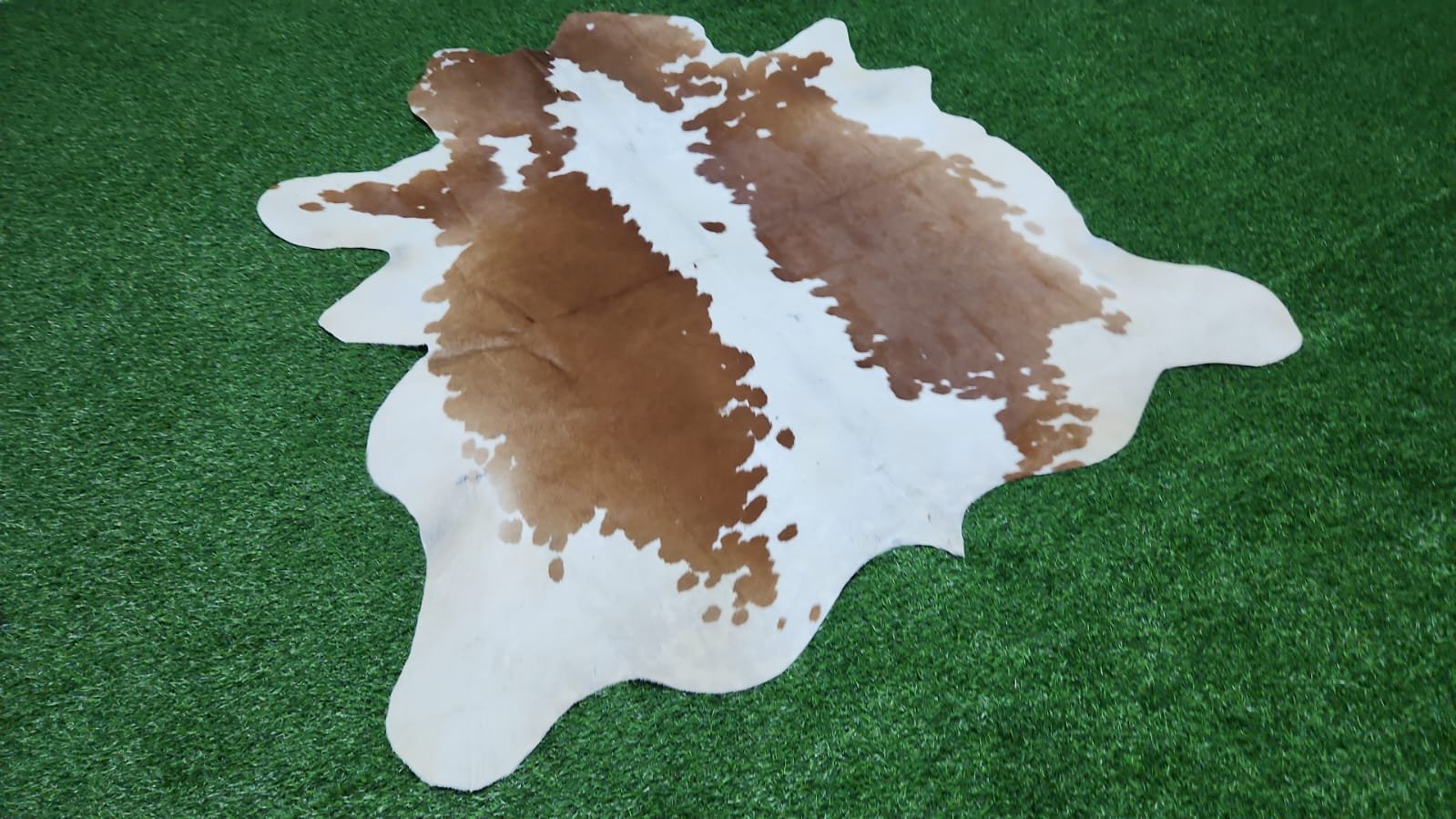 Brown and white cowhide rug