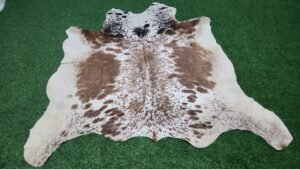 White and brown cowhide rug