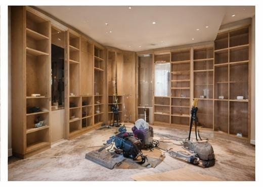 Walk-in closet carpentry work in progress with wooden shelving installation.